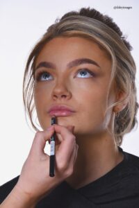applying lipstick on bride