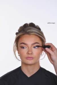 applying mascara on bride