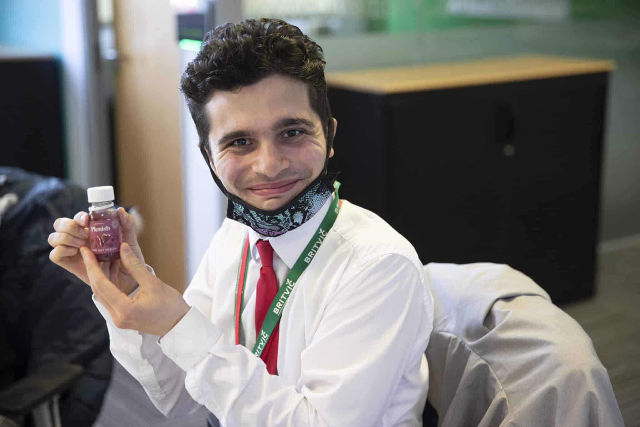 student holding up a drink