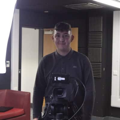 Student looking at camera in college tv studio