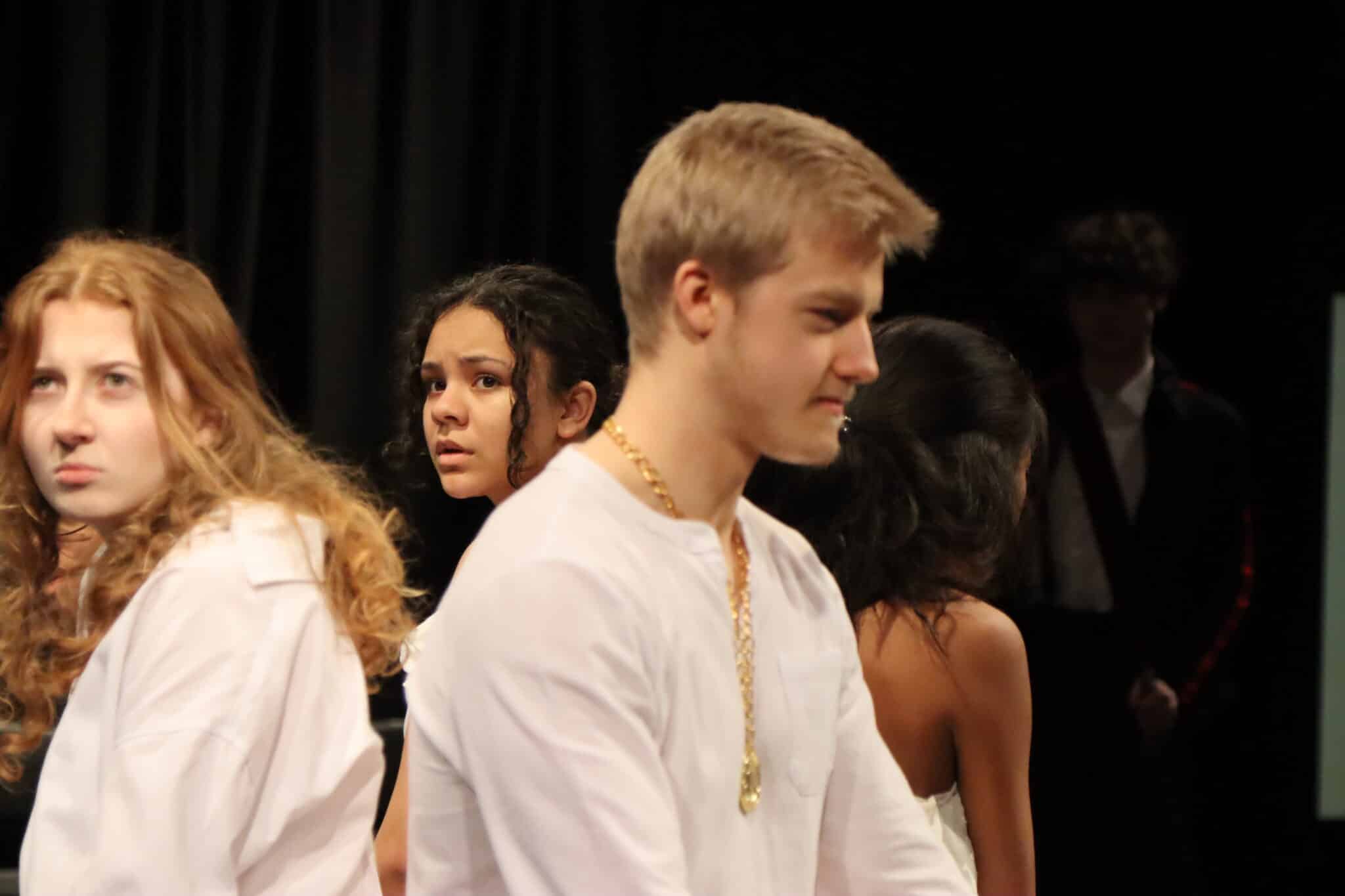 Performers sitting in white clothes