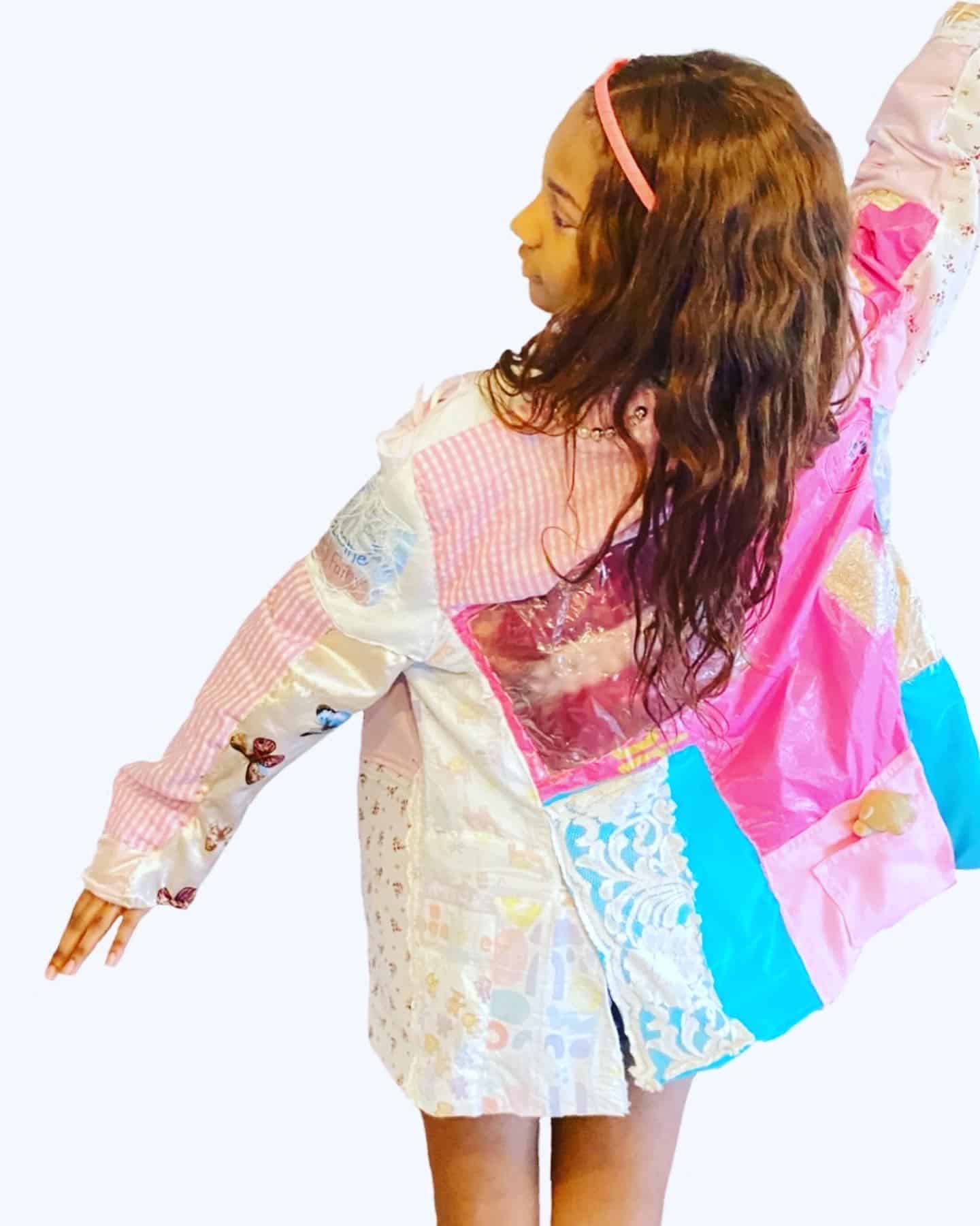 girl standing with patchwork shirt