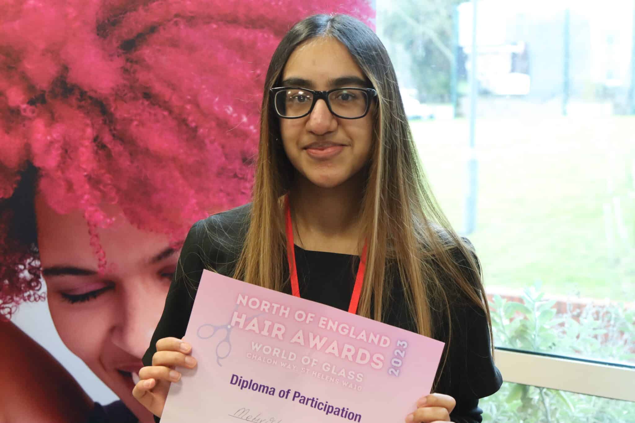 Barbering students win big - diploma of participation certificate held