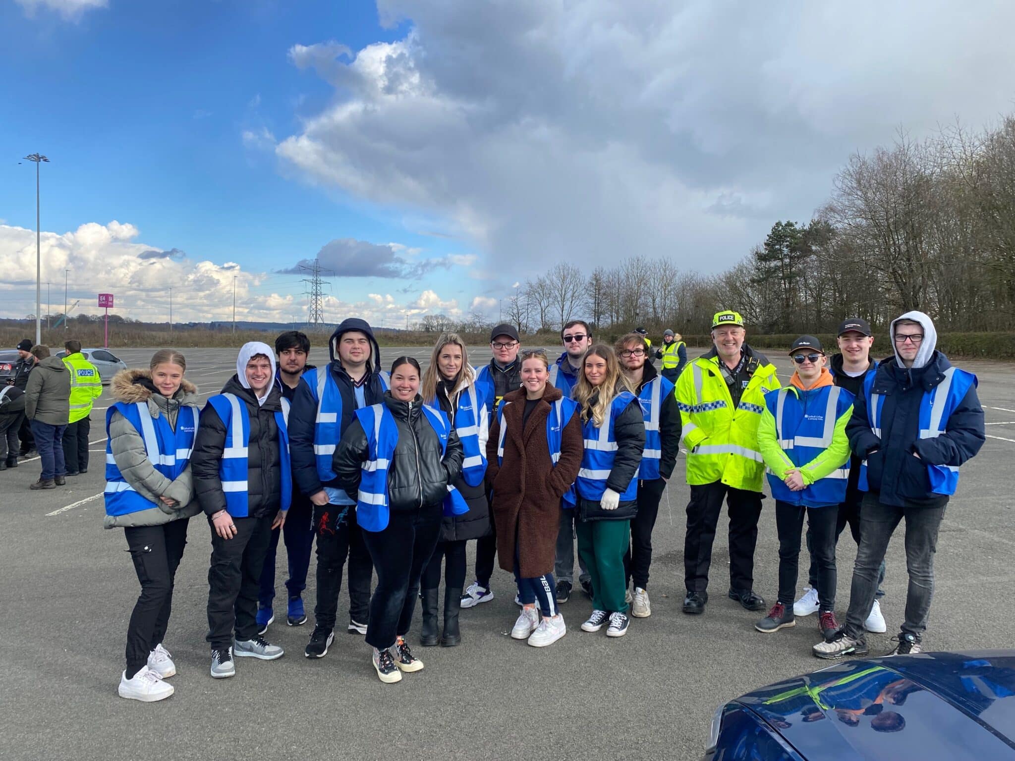 Policing students in blue high vis posing for group picture