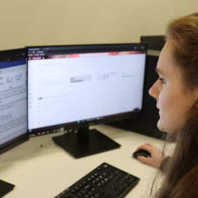 student sat in front of computer screens