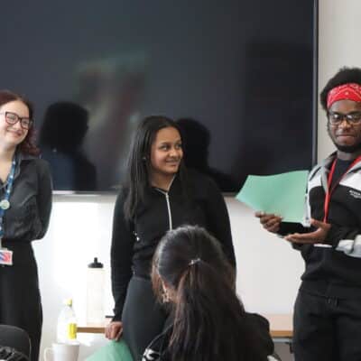 three students delivering a talk