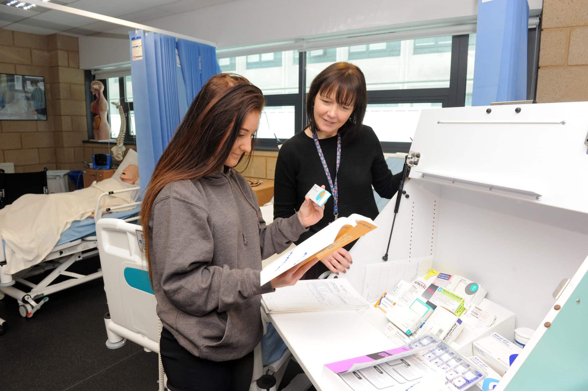 teacher and student looking at medicine