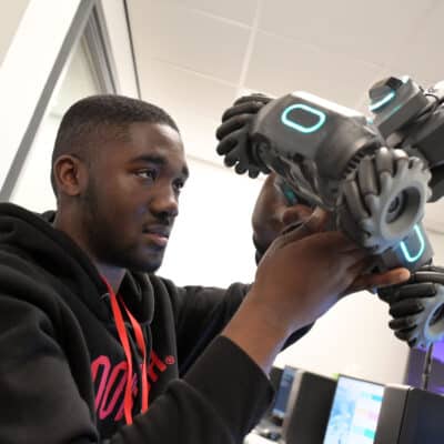 student looking at robot