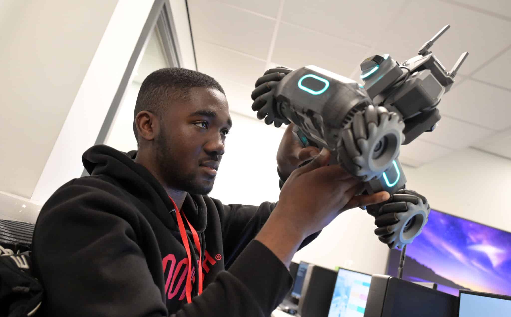 student looking at robot