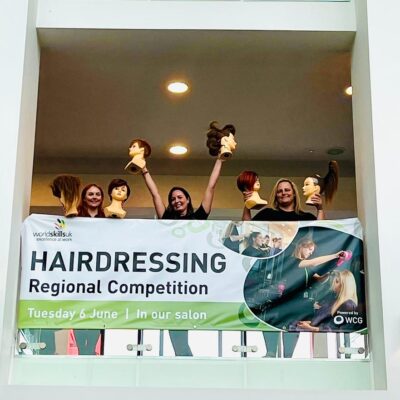 Hairdressing students celebrate in balcony
