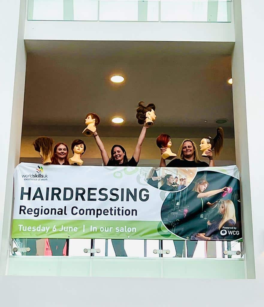 Hairdressing students celebrate in balcony