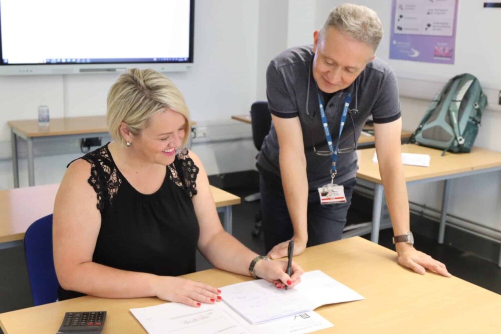 Maths lecturer helping student with maths