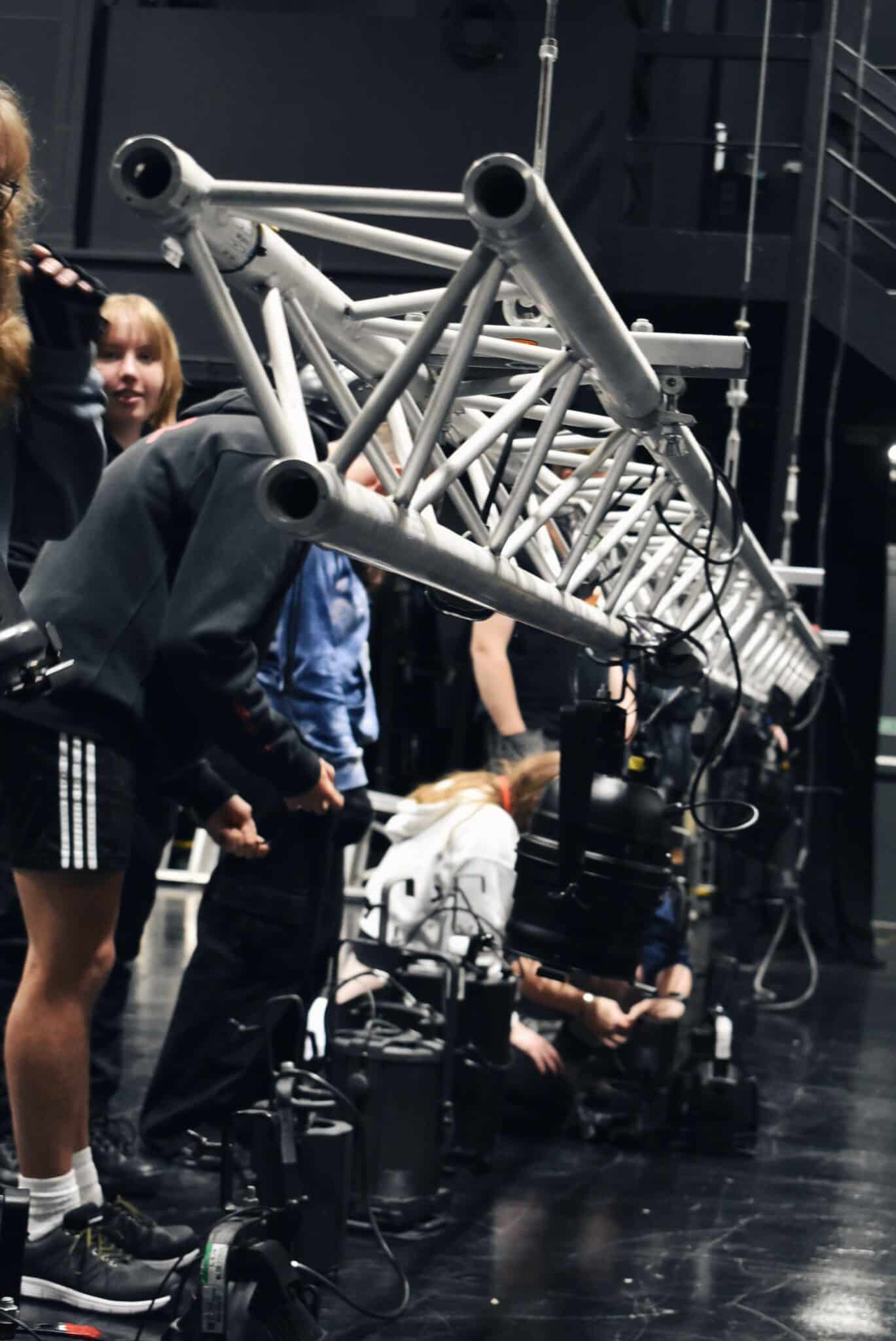 students working under a lighting rig