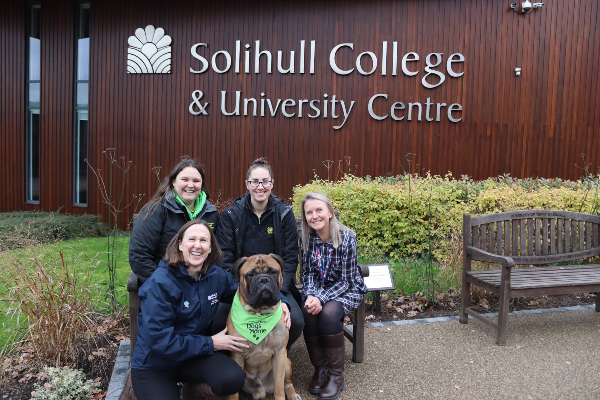 Cooper the dog with college and Birmingham Dogs home staff