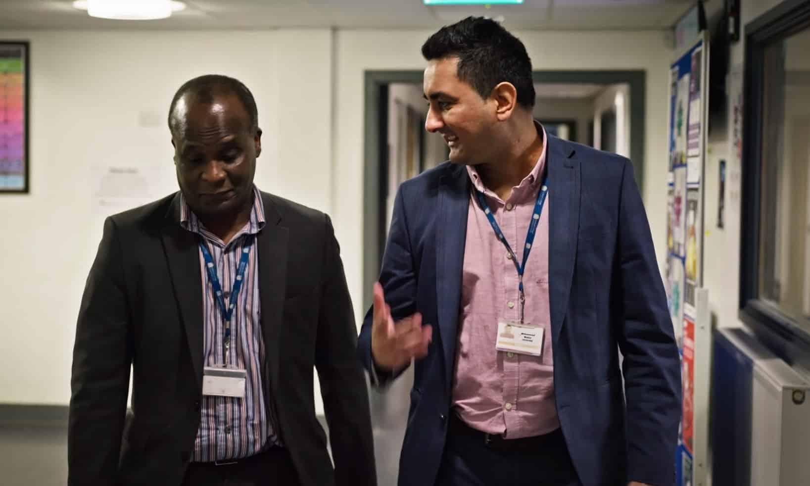 College staff talking in corridor