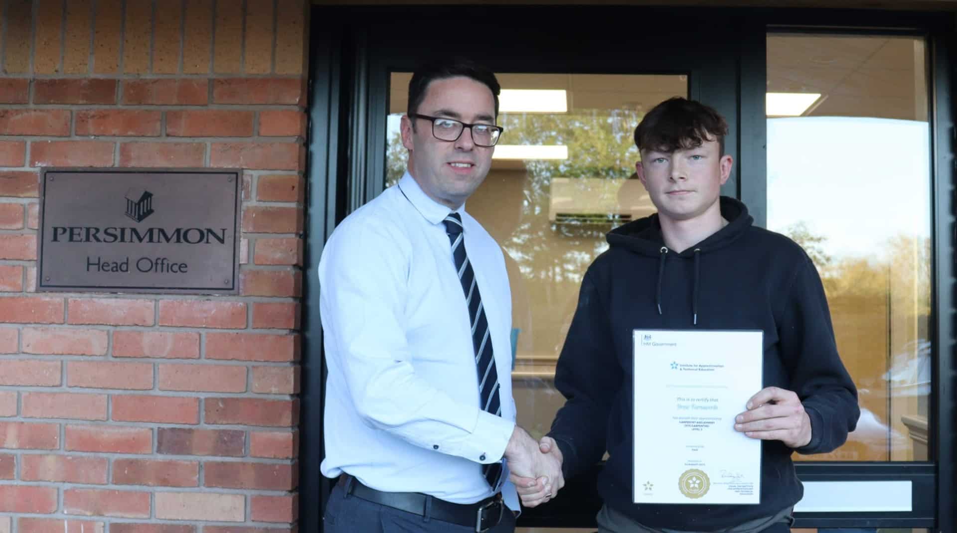 Drew with his certificate