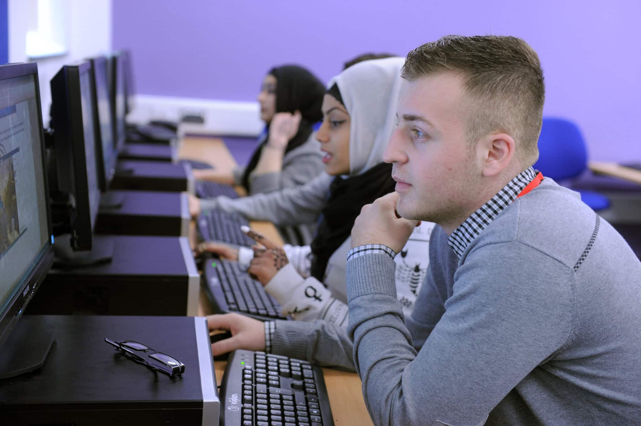 students sat in line looking at computer