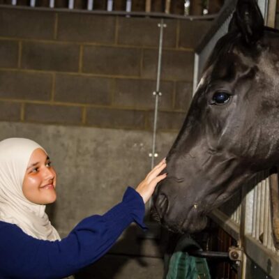 student petting horse