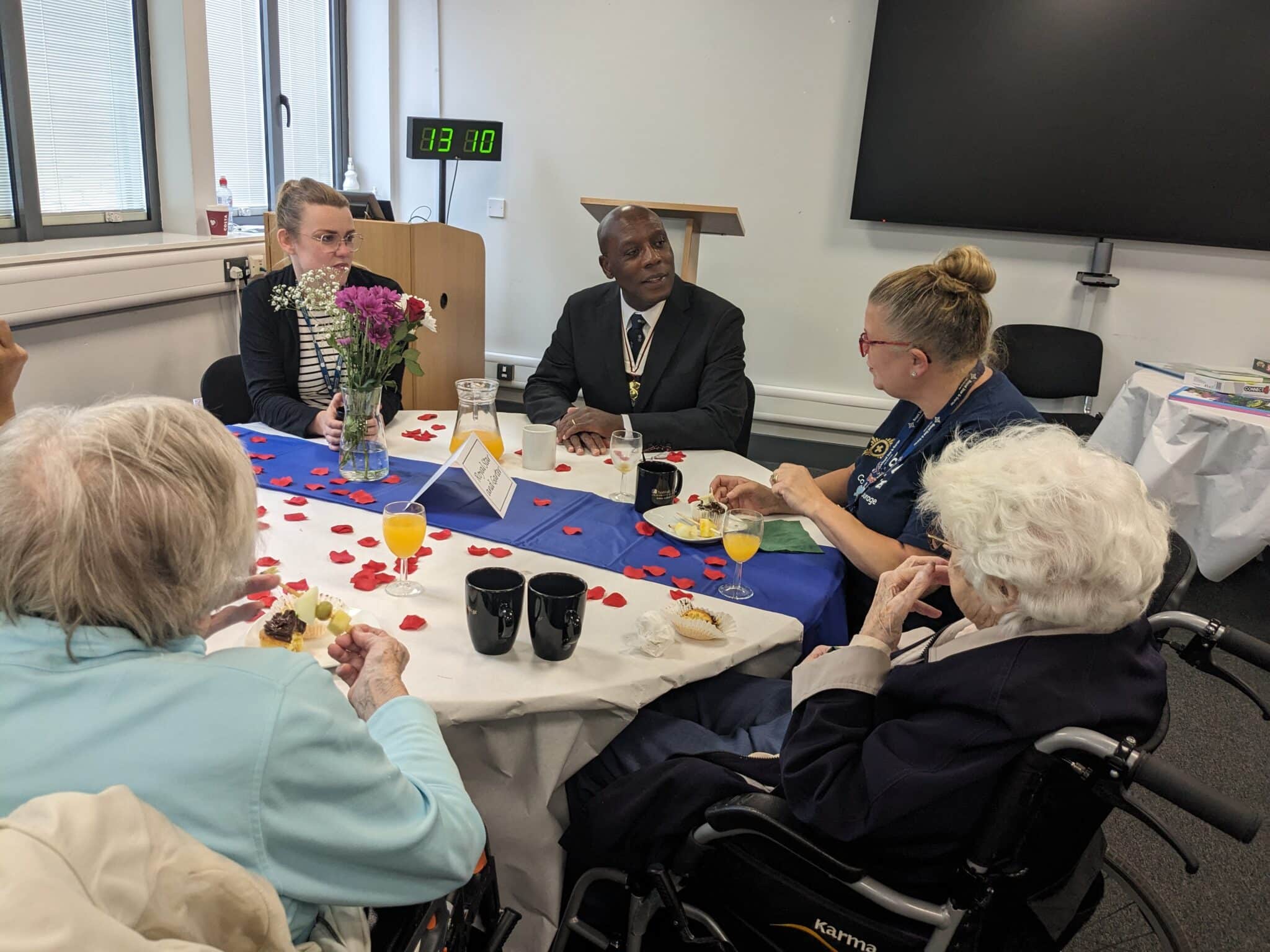 people sitting at tables enjoying tea