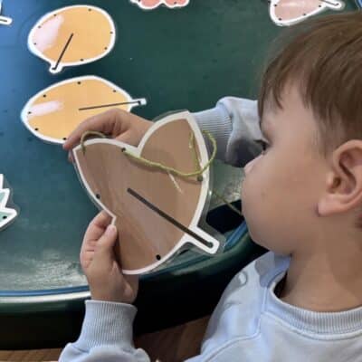 child playing with pictures of leaves