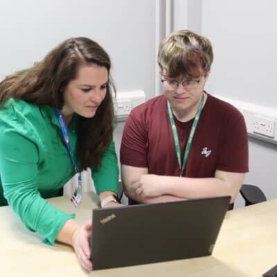 GSCE English student ray, wins National writing competition - Rachel and Ray looking at the laptop