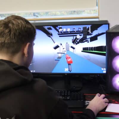 Matthew playing his game at his PC