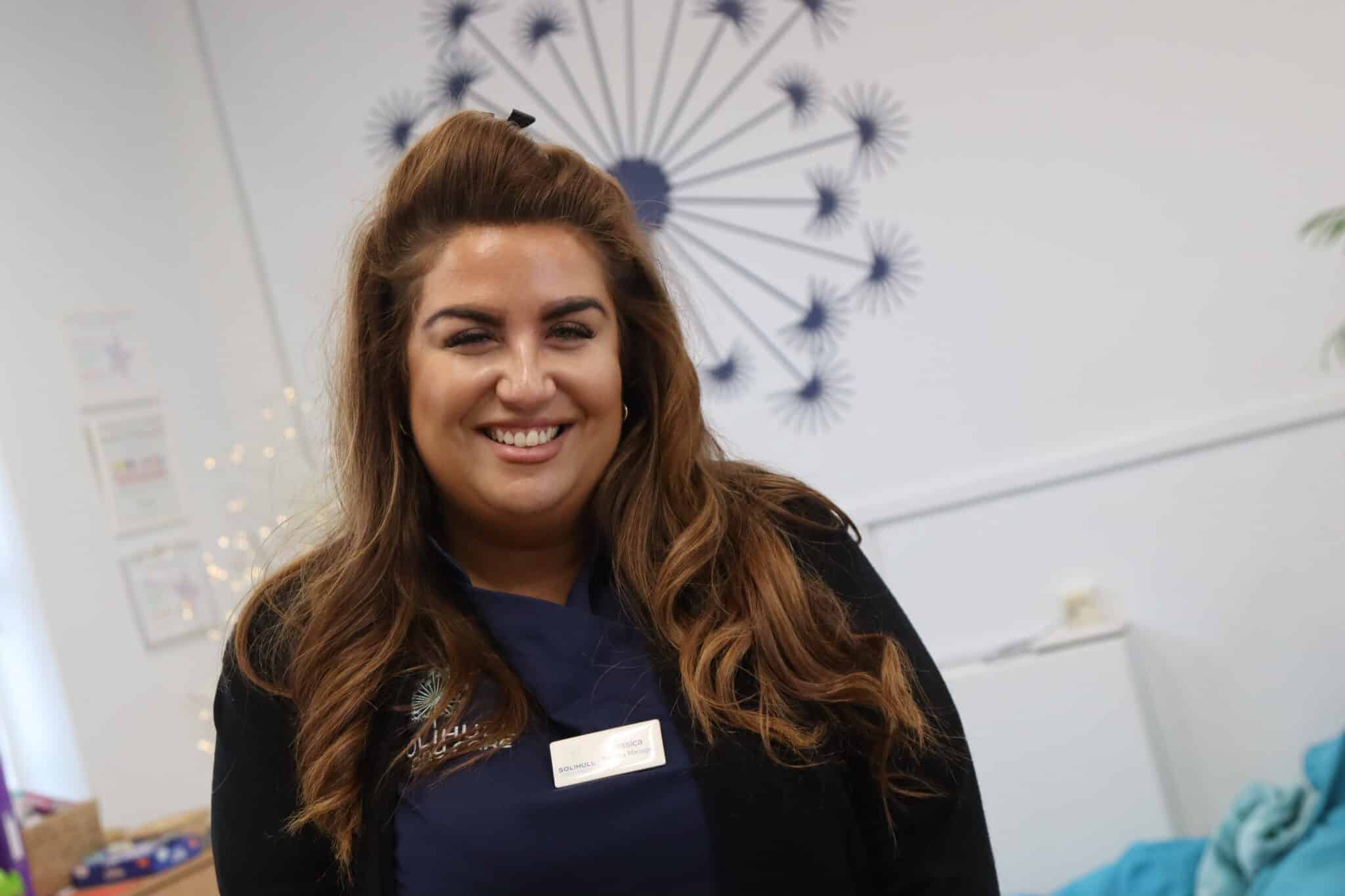 Jess Dolan standing in front of camera in the day care room
