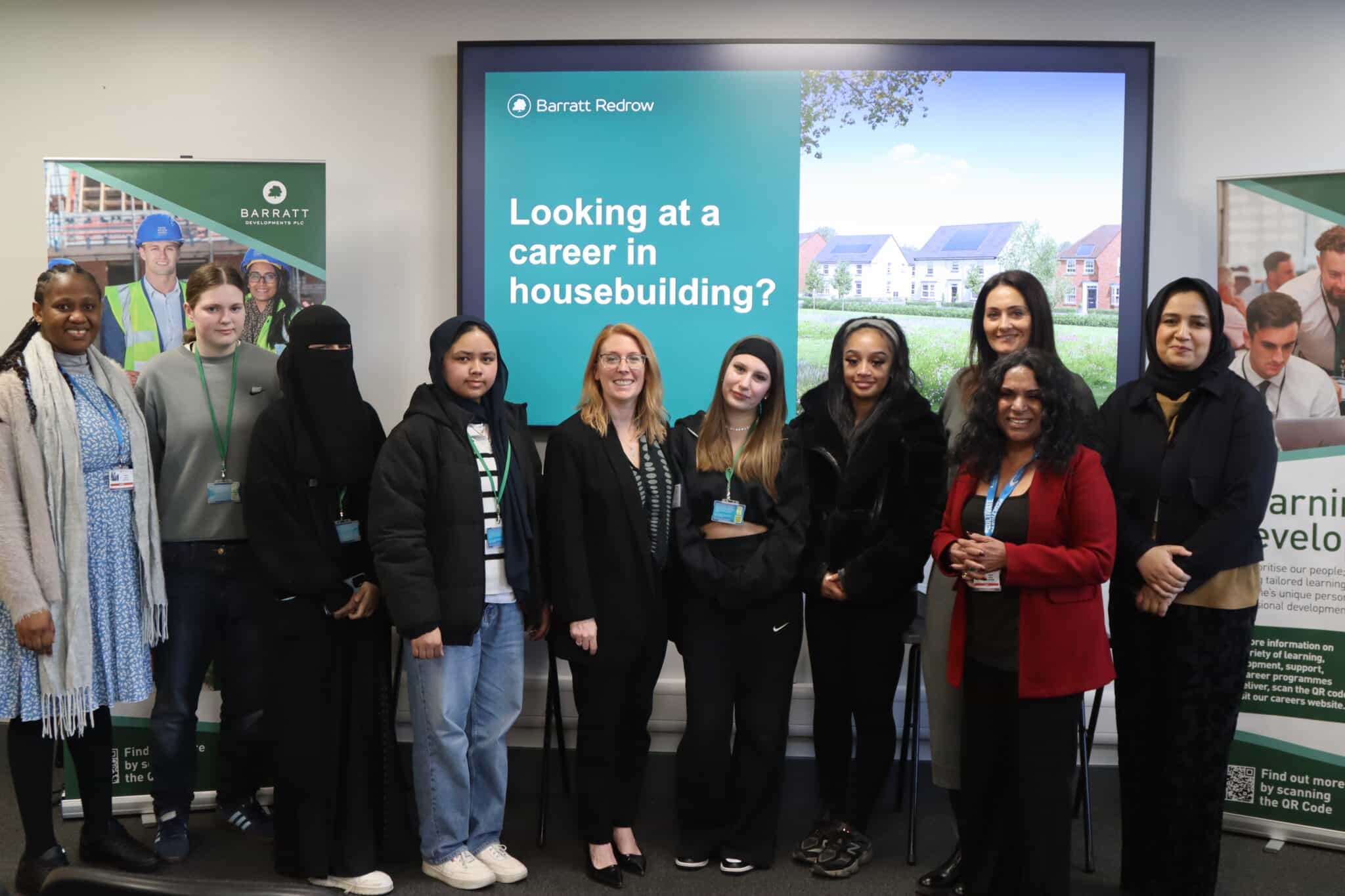 Women involved in the Construction & Built Enviroment course line up in front of presentation