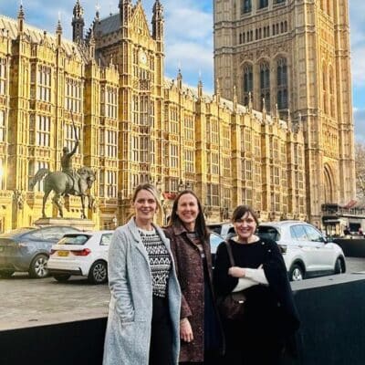 The team standing outside the Houses of Parliament