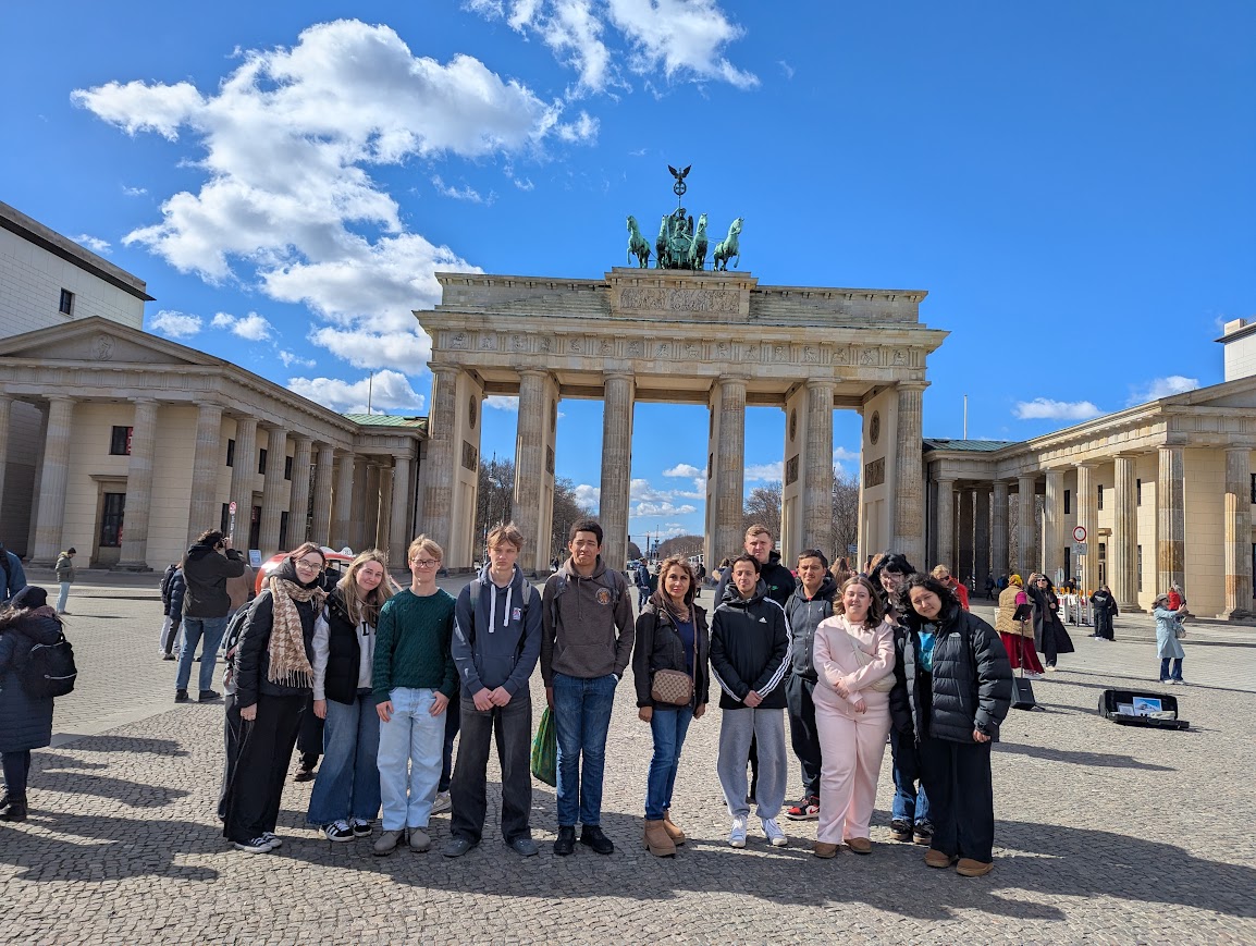 Students smiling in front of a tower