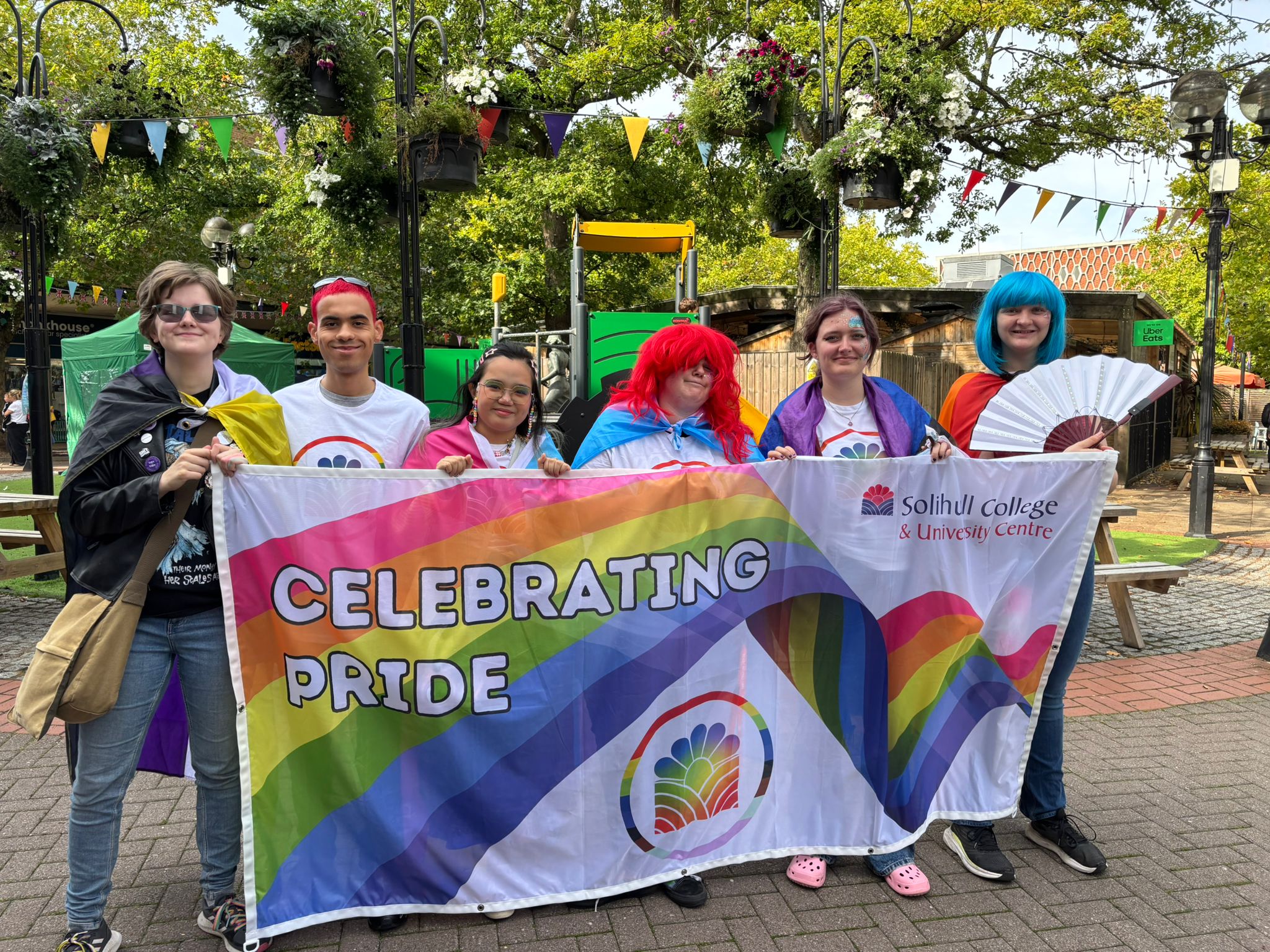 Students with the College Pride banner
