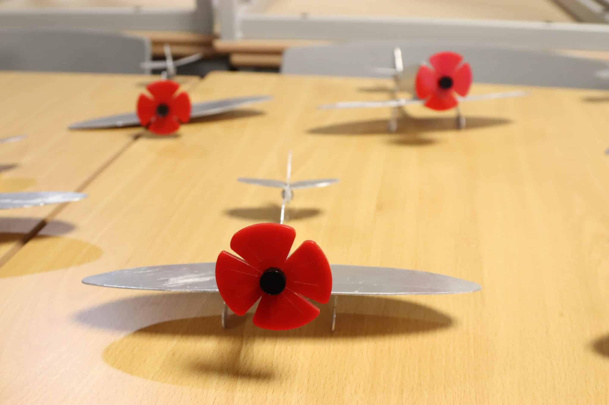 Small metal spitfires – propellers replaced with 3D printed poppies, made by Level 2 Engineering students