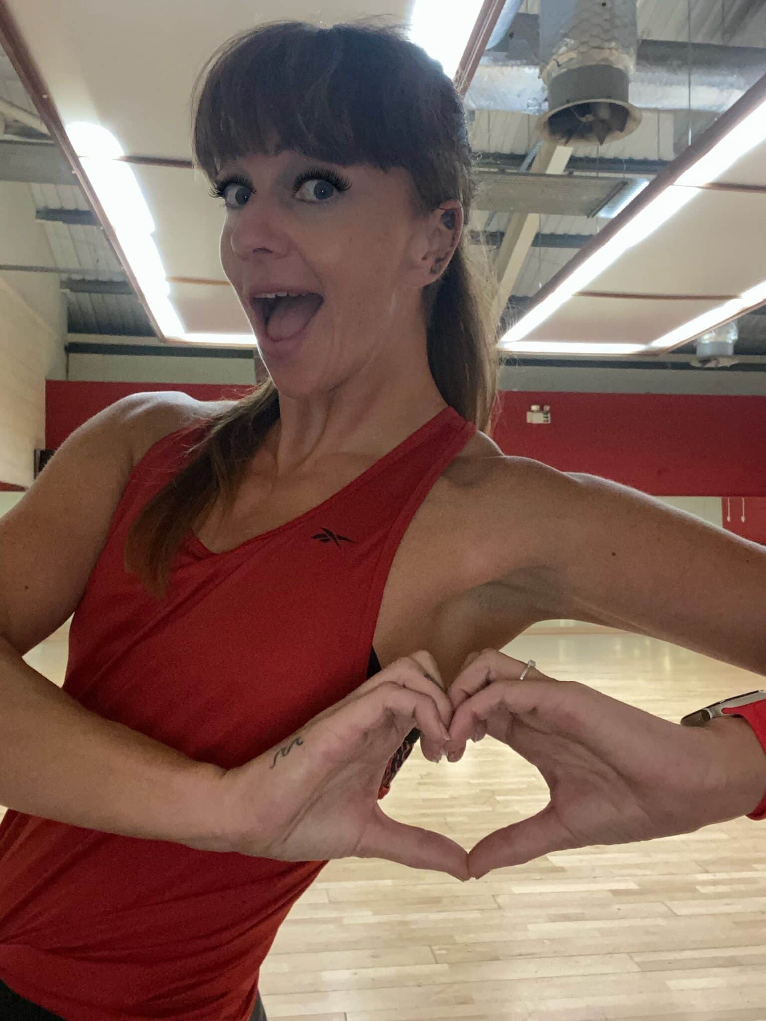 Sarah doing a heart pose with her hands