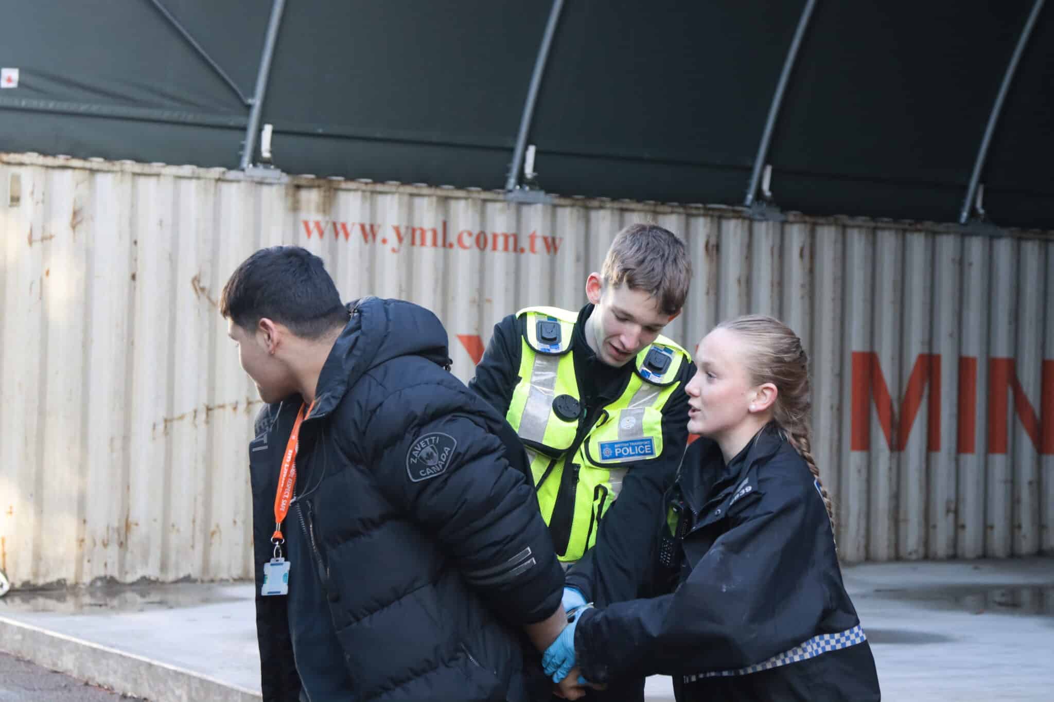 mock arrest during live simulation for students