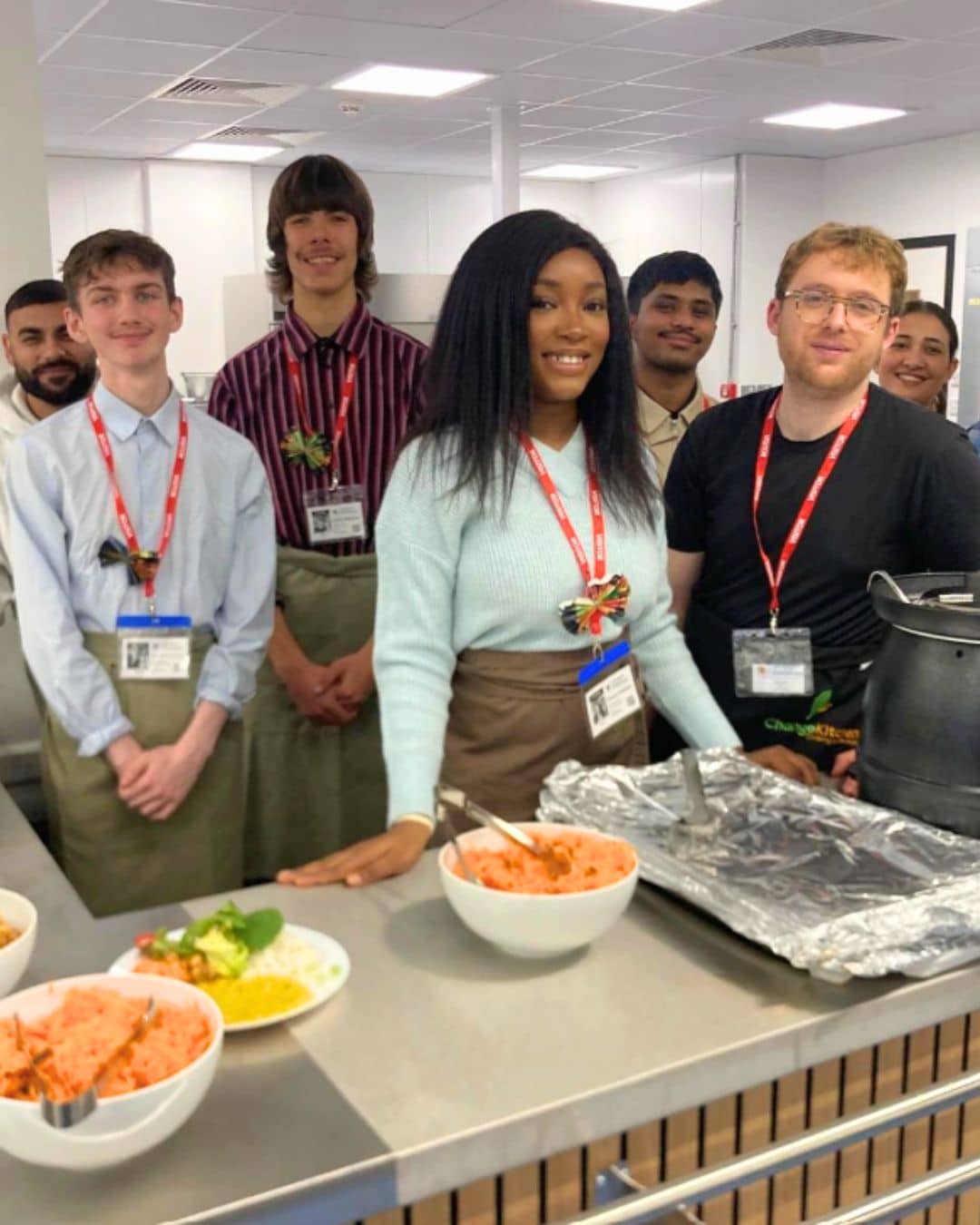 group of students standing in front of kitchen