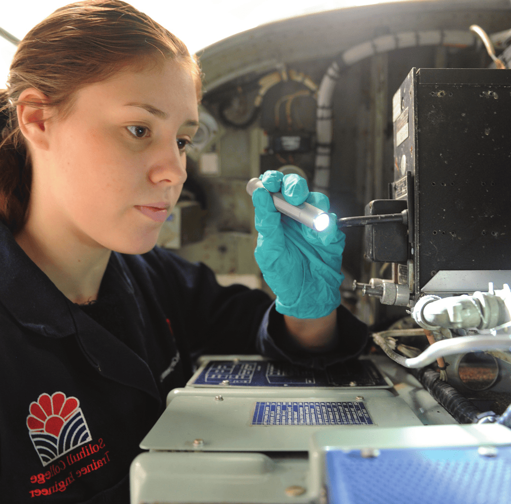 Engineering student inspects equipment on industry placement.