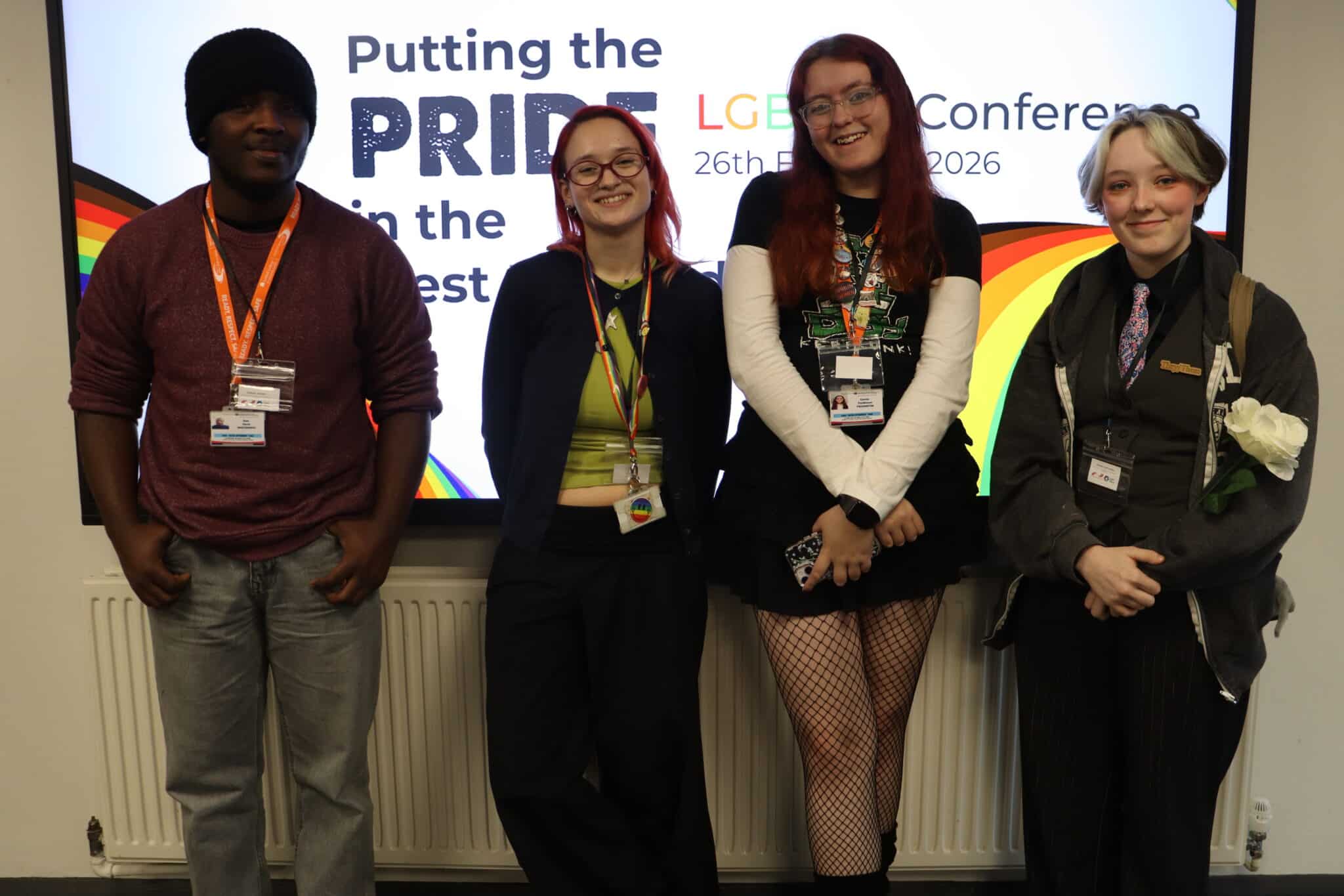 4 students smiling the camera