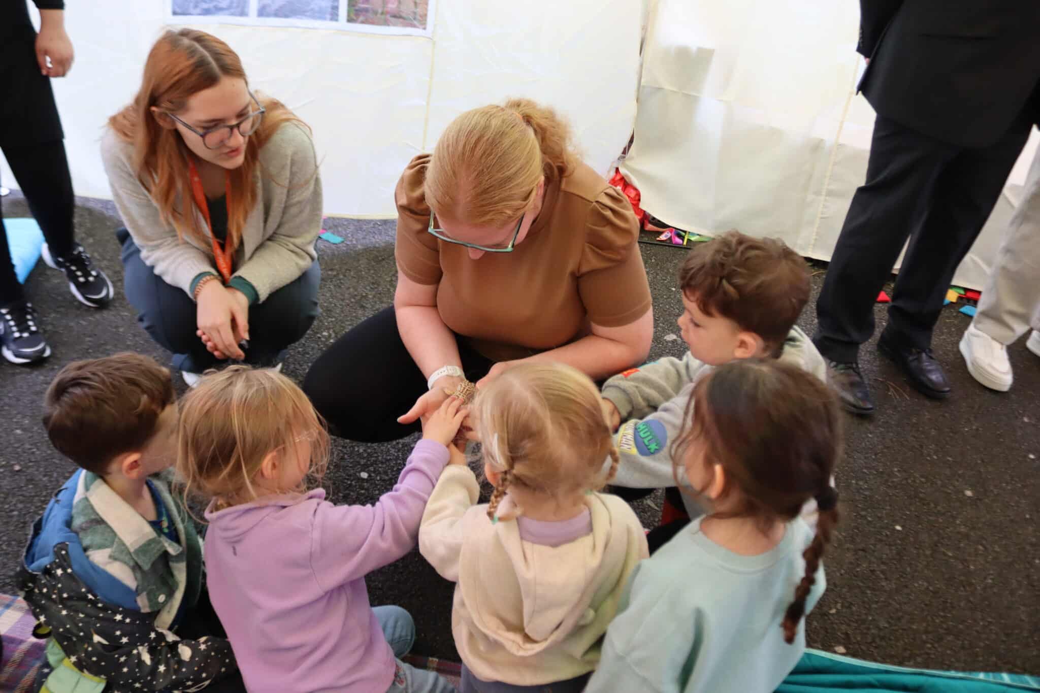 Children from Mad Hatters Day Nursery at a College event with students