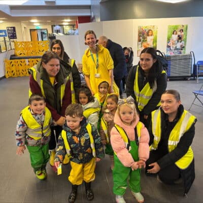 Staff and children from Mad Hatters Day Nursery with students for a Children In Need event